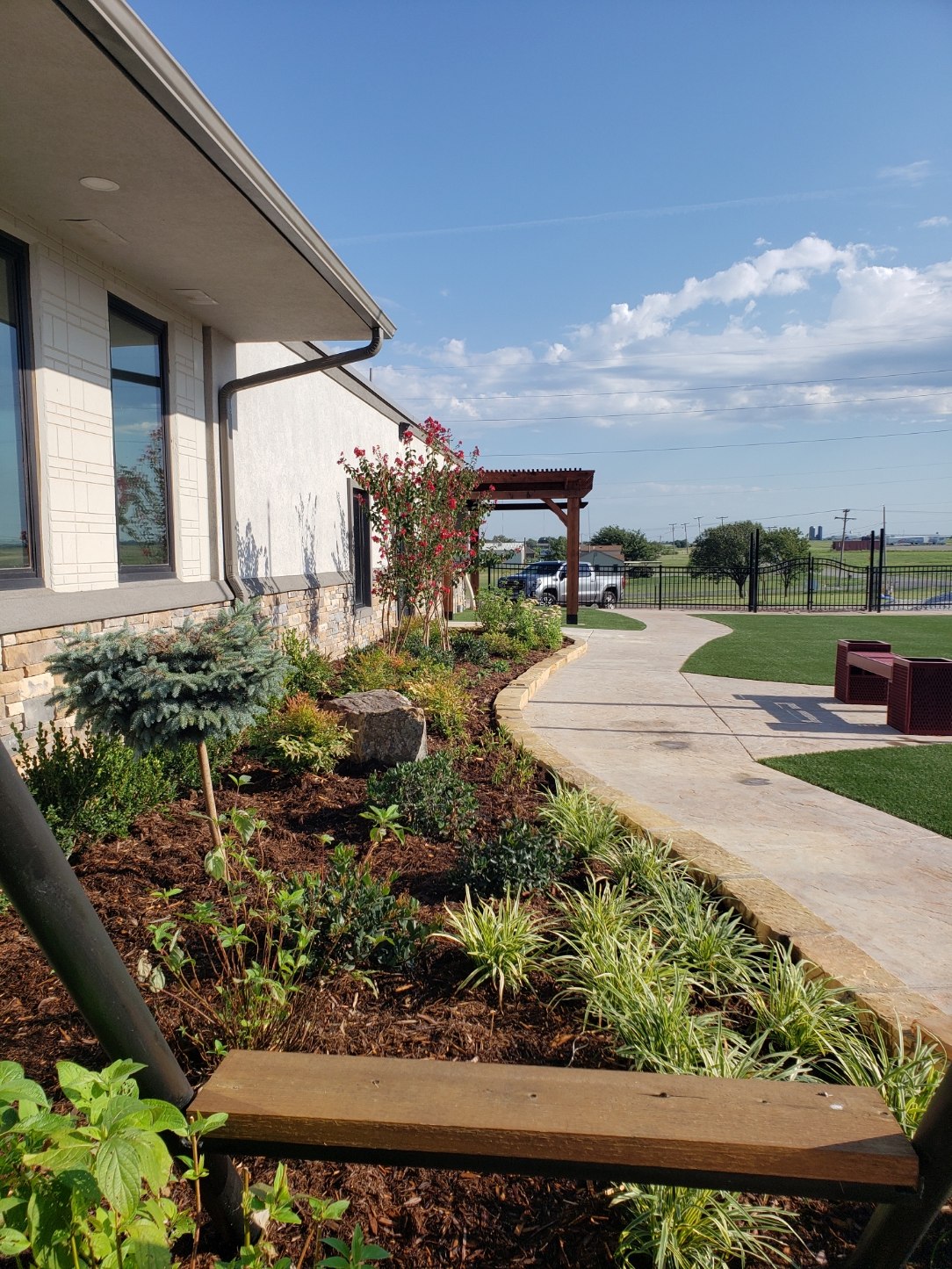 Finished commercial walkway with stone borders and landscaping in Lawton, Oklahoma